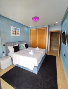 a bedroom with a large white bed in a room at Appartement de luxe sur agadir bay in Agadir