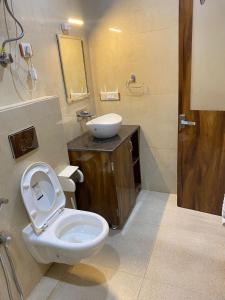 a bathroom with a toilet and a sink at MS RESORT in Dalhousie