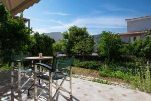 a table and two chairs sitting next to a table at Pappas Family House in Nafplio +34 photos