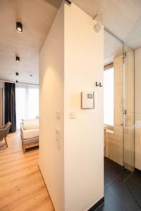 a room with a glass door leading to a bedroom at GRIMMINGlofts in Bad Mitterndorf