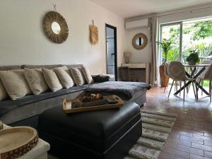a living room with a couch and a table at Le Bailli Saint Tropez in Saint-Tropez