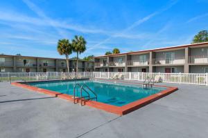 a swimming pool in front of a apartment building at Quality Suites Wildwood - The Villages in Wildwood