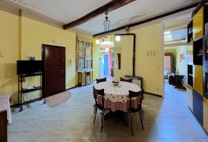 a dining room with a table and chairs in a room at La casa di Piermaria in Varazze