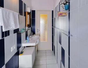 a bathroom with a sink and a mirror at La casa di Piermaria in Varazze +5 photos