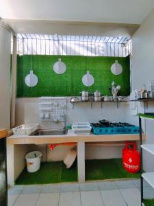 a kitchen with a sink and a stove at HOST HOMES-SANDY LANE in Tacloban