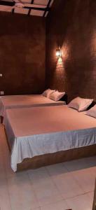 a pair of beds in a room with at Sriyantha Rest in Kataragama
