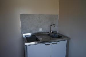 a kitchen with a sink and a counter top at Orkla Camping in Orkanger