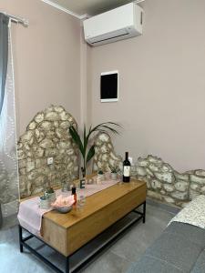 a room with a table with wine bottles on it at Spitaki in Alepou