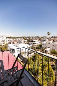 a balcony with two chairs and a view of a city at Limon Inn Hotel, Taşucu in Tasucu +37 photos