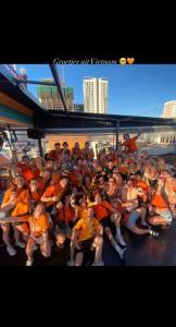 a large group of people wearing life jackets sitting on a boat at Saigon Rooftops Hostel in Ho Chi Minh City