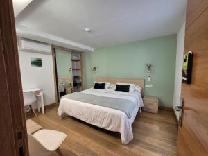 a bedroom with a large bed and a desk at Pension Joakina in San Sebastián