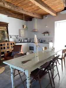 a kitchen and dining room with a table and chairs at Le Mottay Guesthouse in Saint-Père-en-Retz
