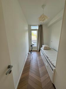 een kleine kamer met een bed en een raam bij Old South - Luxury Apartment in Amsterdam