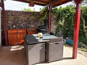 an outdoor patio with a table and a grill at Vila Daddy in Deva