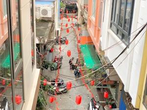 an overhead view of a city street with red lanterns at Friendly room in Hai Phong