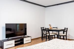 a living room with a dining table and a tv at Lady-s in Cluj-Napoca