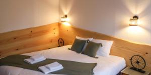 a bedroom with a large white bed with two pillows at Maison Tournesol in Gan
