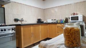 a kitchen with wooden cabinets and a microwave and a counter at Nature Retreat - Laurel Forest in Seixal