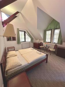 a bedroom with a large bed in a attic at Imola Garden Vendégház in Balatonfüred