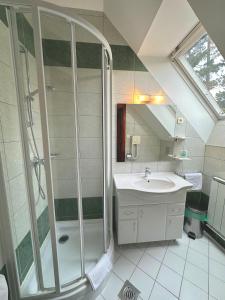 a bathroom with a shower and a sink at Imola Garden Vendégház in Balatonfüred