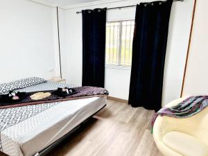 ein Schlafzimmer mit einem Bett und einem Fenster in der Unterkunft Jardines del Sur, 3 Bedroom in Los Cristianos + 19 Fotos