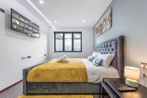 - une chambre avec un grand lit et un bureau dans l'établissement Serviced Golders Green Apartment near Camden London - 2, à Londres