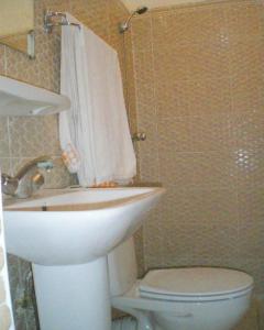 a bathroom with a sink and a toilet at TIRIKA Hôtel La Gazelle in Zemmour Touirza