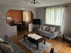 a living room with a couch and a table at Moravian Haven in Christ Church