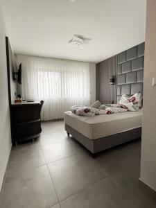 a bedroom with a bed and a television in it at Hotel Löwenstein in Lich