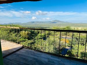 a balcony with a view of the mountains at Tree house in Ngong