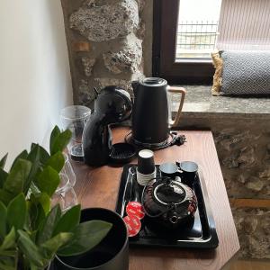 a tea kettle on a tray on a table at Olympus Stone Lodge in Litochoro