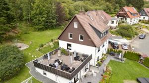 an aerial view of a large white house at Pension Haus am Wald in Braunlage
