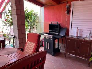 an outdoor patio with a stove and a table at ArtWoodResidence in Ankaran