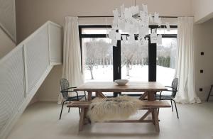 a dining room with a table and a chandelier at Szarata204 in Sărata
