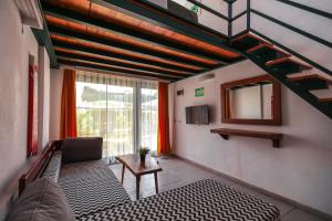 a living room with a couch and a table and a mirror at Limon Inn Hotel, Taşucu in Tasucu