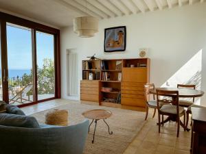 a living room with a table and a dining room at Villa Ghezzi Sea View in Casamicciola Terme
