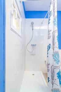 a bathroom with a shower with a shower curtain at Sestanyol in Colonia de Sant Pere +22 photos