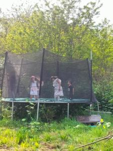 three children are standing on a trampoline at chez H&M in Saint-Cyr-lʼÉcole