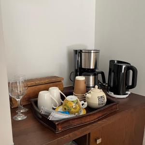a tray with coffee makers and cups on a table at Olympus Stone Lodge in Litochoro