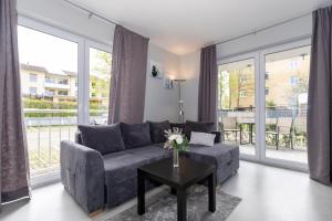 a living room with a couch and a table at Hotel zur Traube in Kühlungsborn