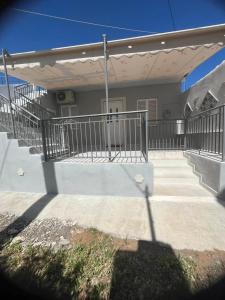 ganek domu z poręczą i schodami w obiekcie Blue Mind House w mieście Nea Kios