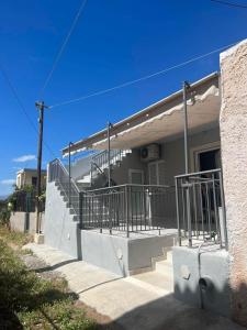 a house with stairs on the side of it at Blue Mind House in Néa Kíos