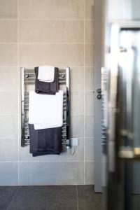 a towel rack in a bathroom with towels at Bridge Inn Studio Apartments in Donegal