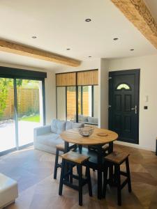 a living room with a table and a couch at Cosy Lodge Sainte Baume in Nans-les-Pins +13 photos