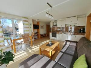 a living room with a couch and a table at Ferienwohnung Sauer in Pfofeld +12 photos