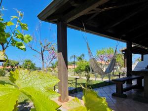 a patio with a hammock in a park at Agriturismo Ninea in Capo Vaticano