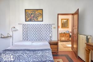 sypialnia z łóżkiem z niebiesko-białą narzutą w obiekcie I 4 Gatti w Bolonii