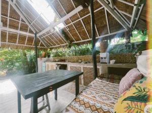 a dining room with a table and a couch at Tropical Jungle Villa 5 min walk to Cloud 9 in General Luna
