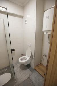 a bathroom with a toilet and a glass shower at Apartman Hana Fojnica in Fojnica