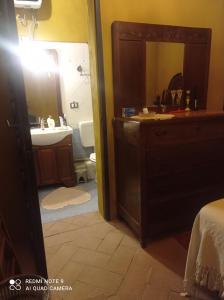 a bathroom with a sink and a mirror at Via VARESE 9C in Castagneto Carducci